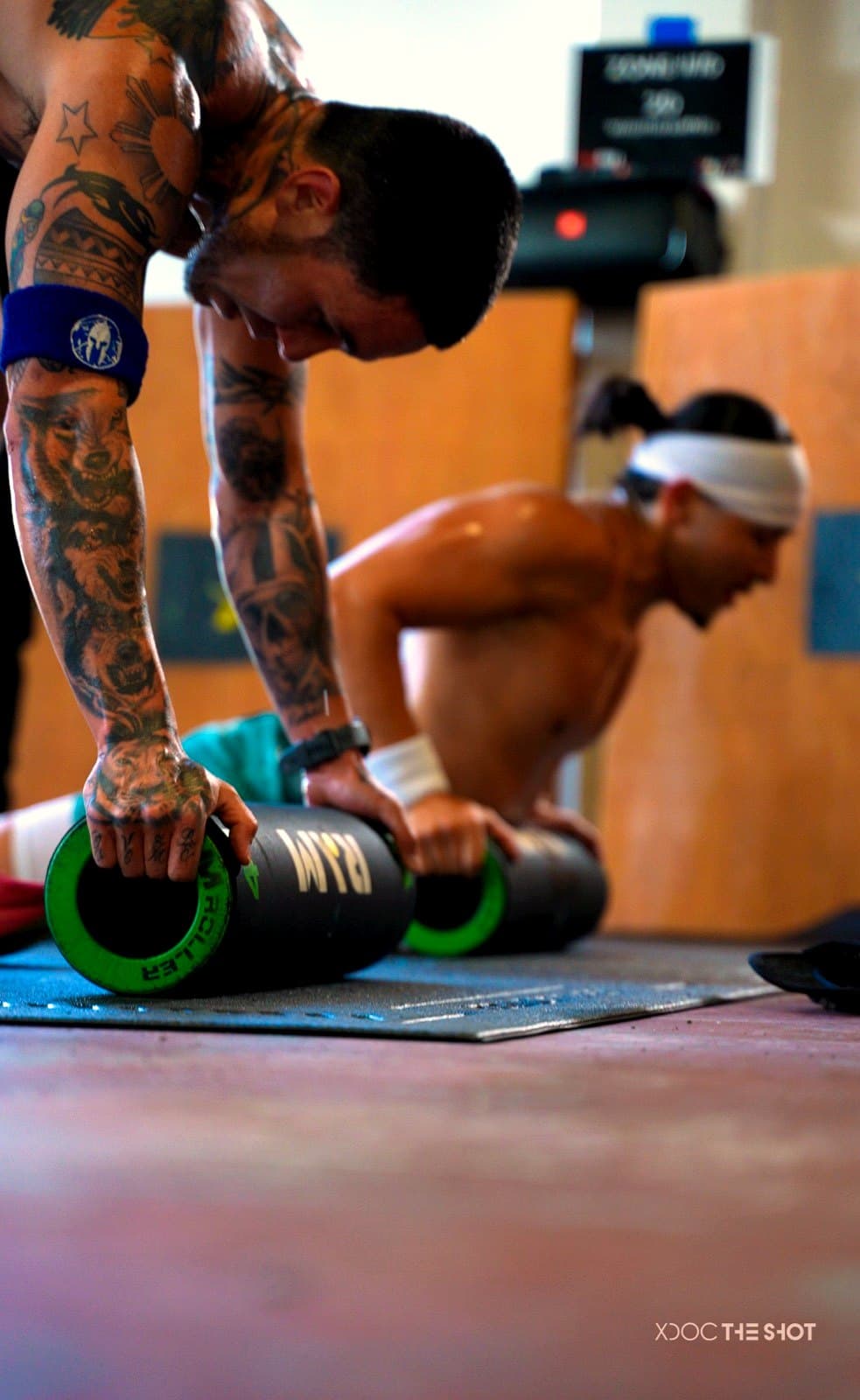 Athletes grinding through a conditioning set on the floor