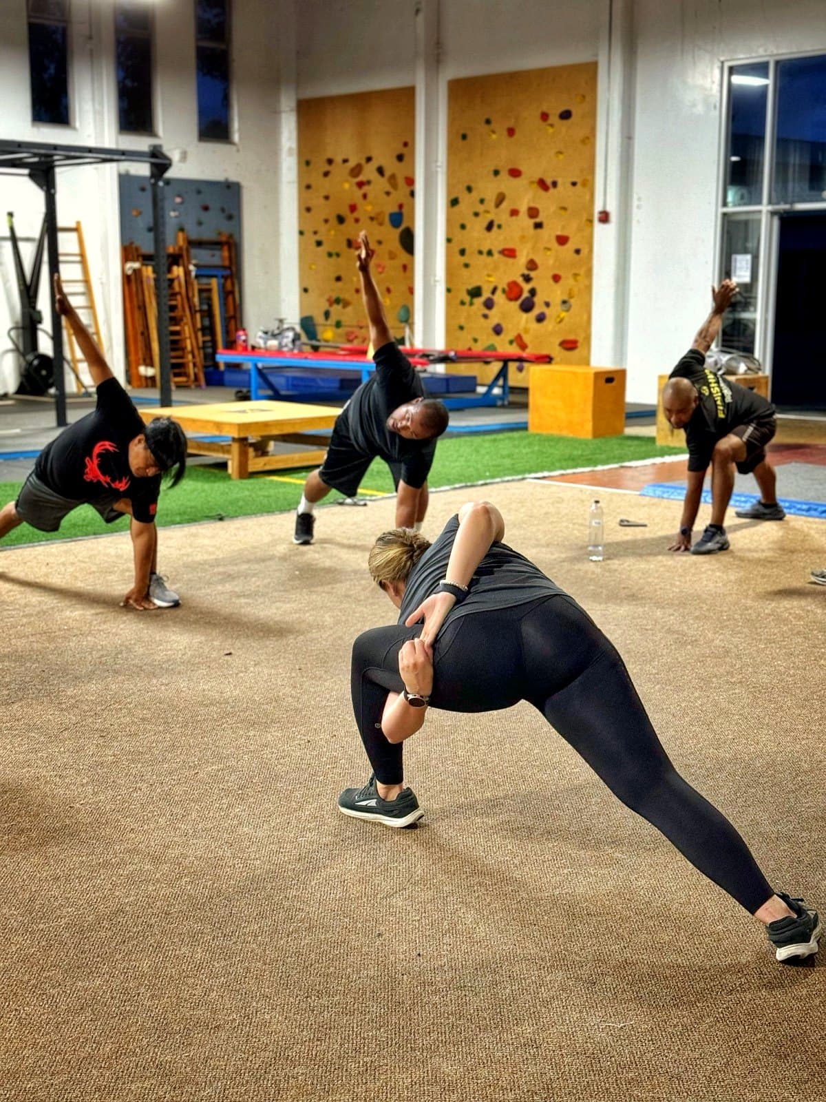 The APX Velocity crew stretching together during a coached warm-up
