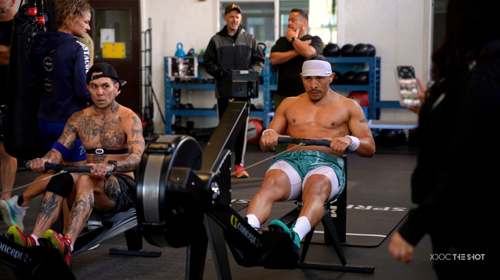Two athletes driving the pace on Concept2 rowers during a hybrid class