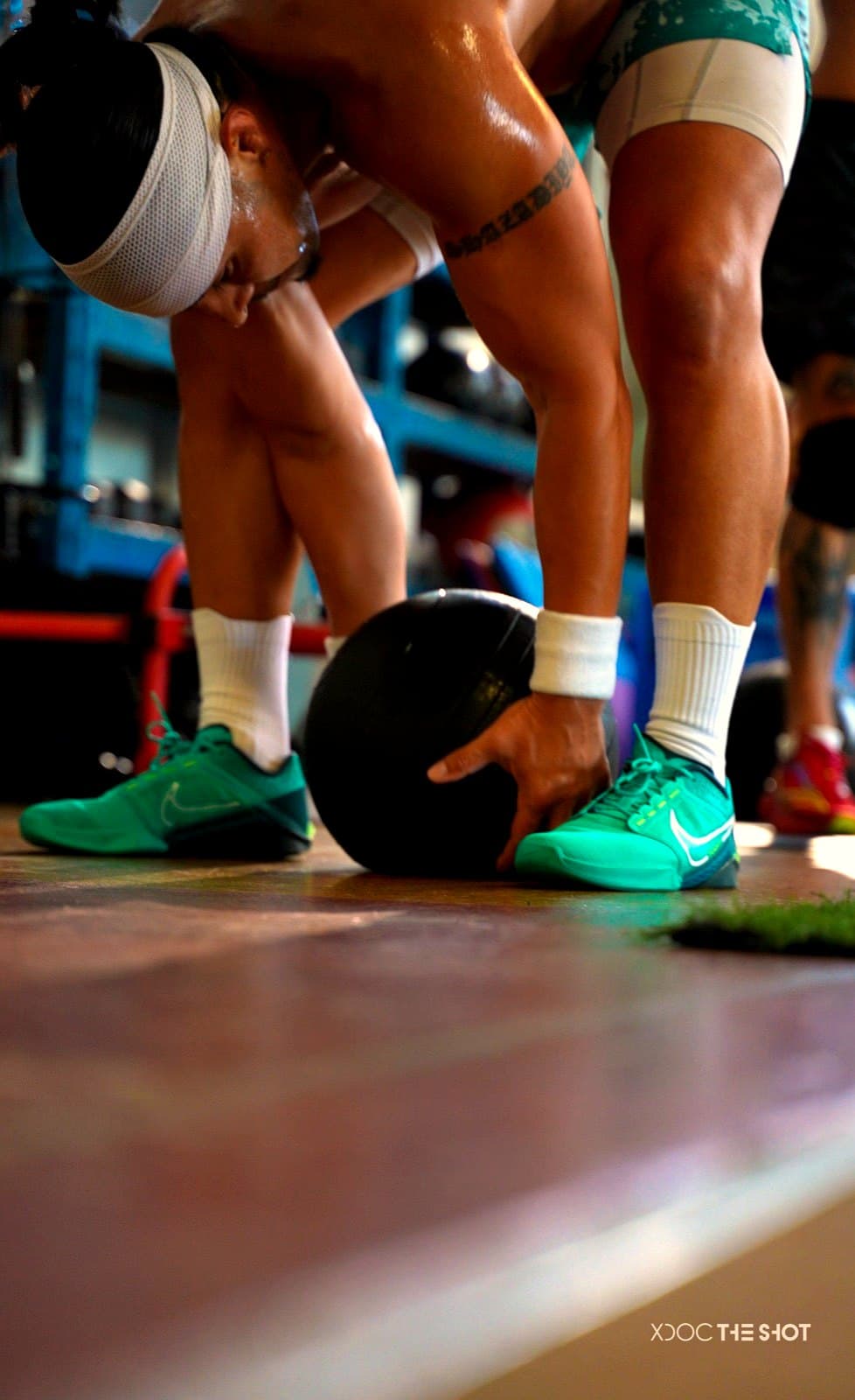 Athlete loading up for a wall ball rep mid-workout