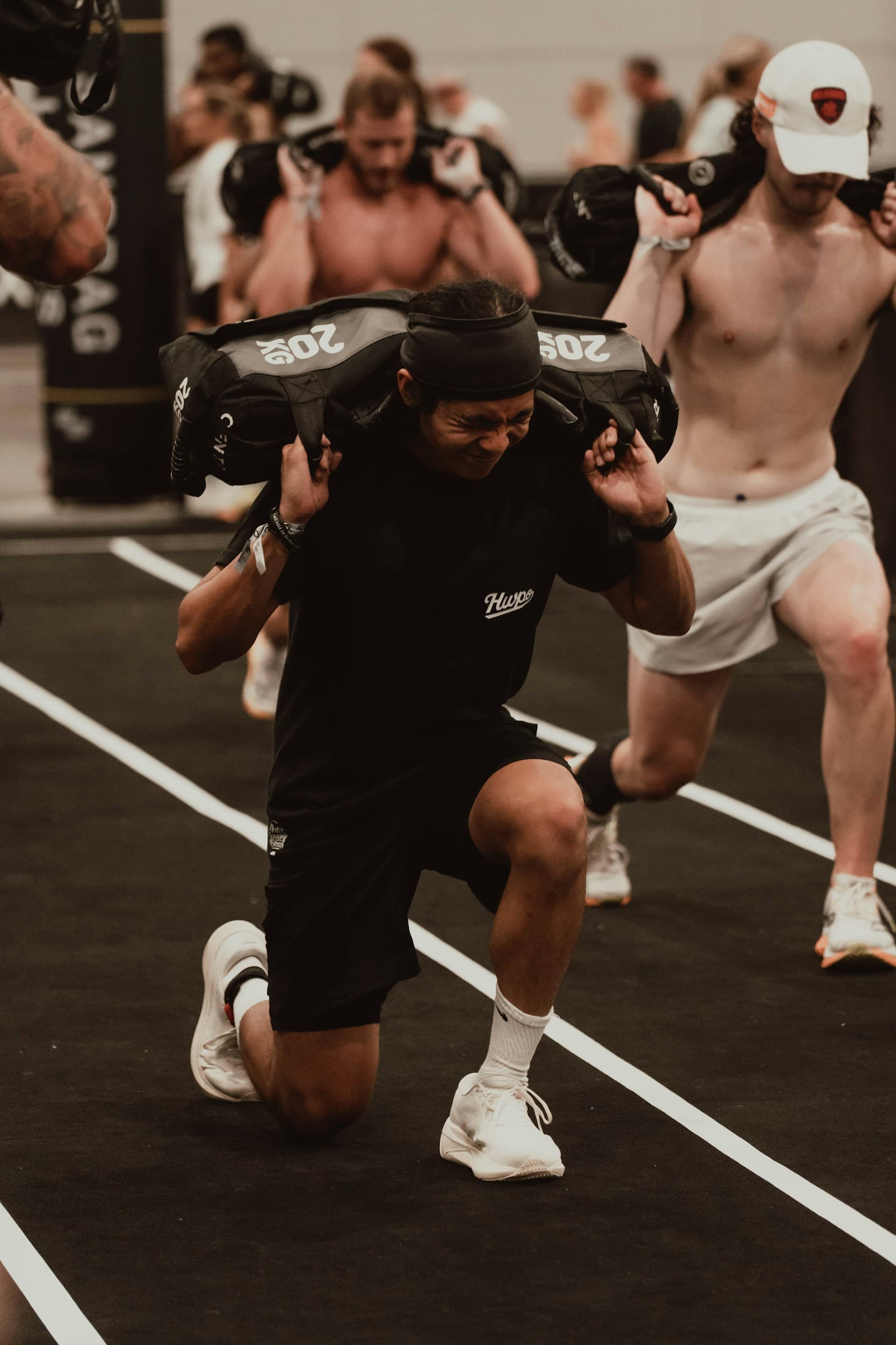 An APX Velocity athlete setting up under a wall ball, one of the eight HYROX stations